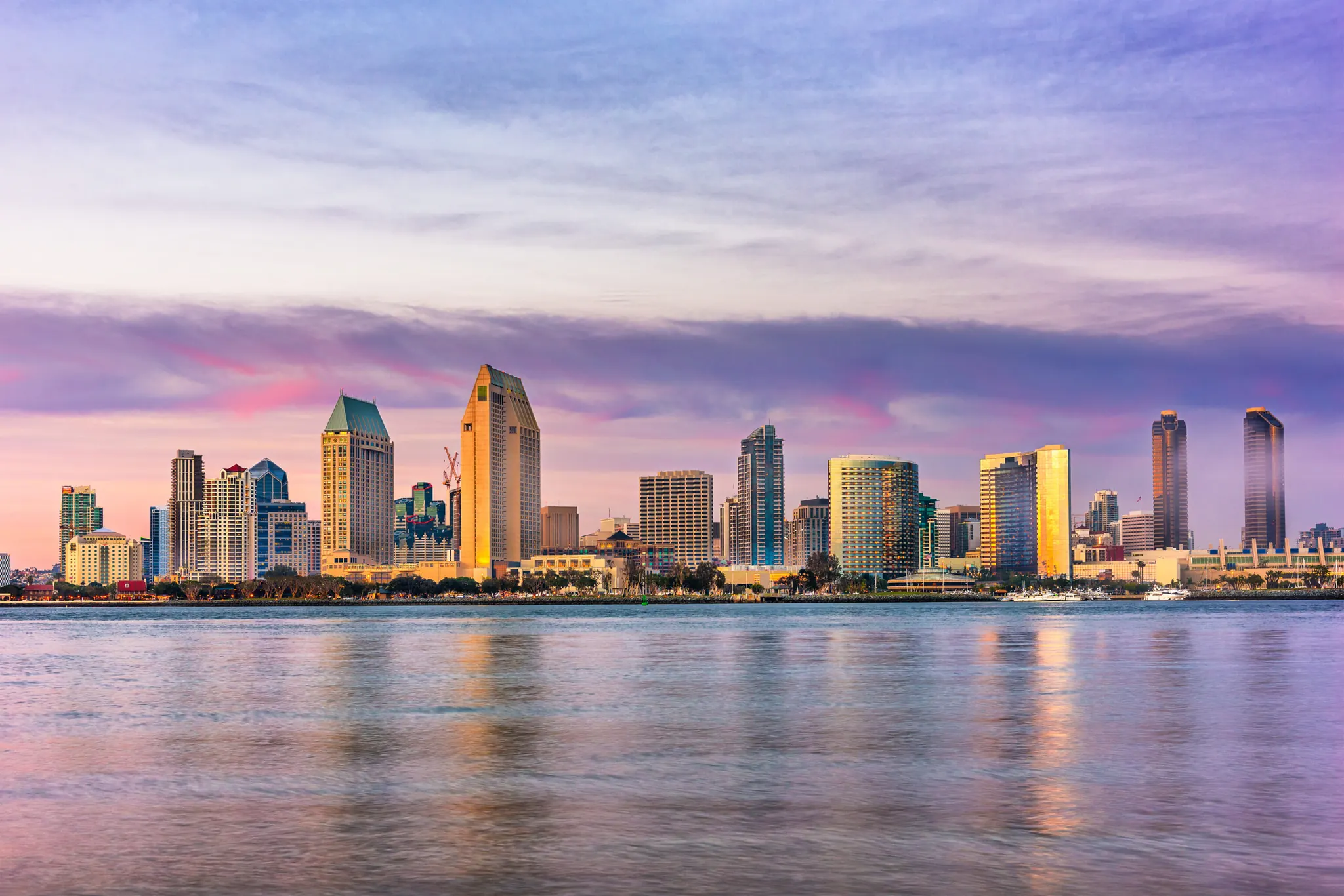 Downtown San Diego skyline at sunset seen across the bay from the Embarcadero